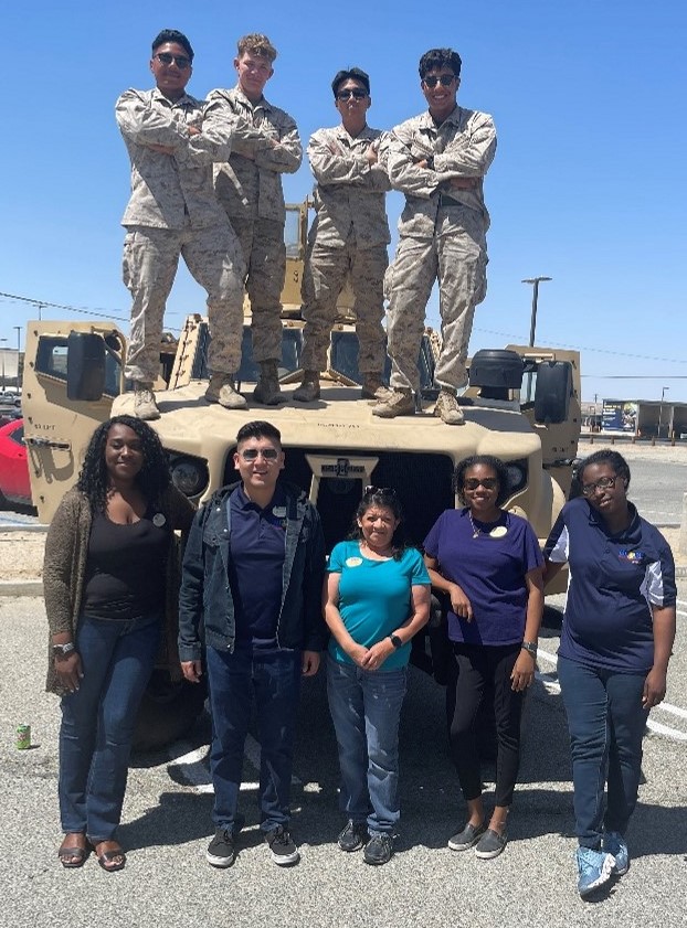 Lcpl Josia A. Hernandez, Lcpl Edgardo E. Ortizromero, Lcpl Cole W. Hinkle, and Lcpl Miguel R. Barrios from 3rd LAR pose with library staff Shirley Oriste, Max Gonzalez, Yvonne Marr, Penelope Placide, and Ashley Harrell at the MCAGCC 29 Palms Libraries’ Mo