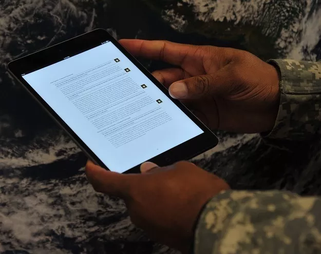 Army member uses a tablet.